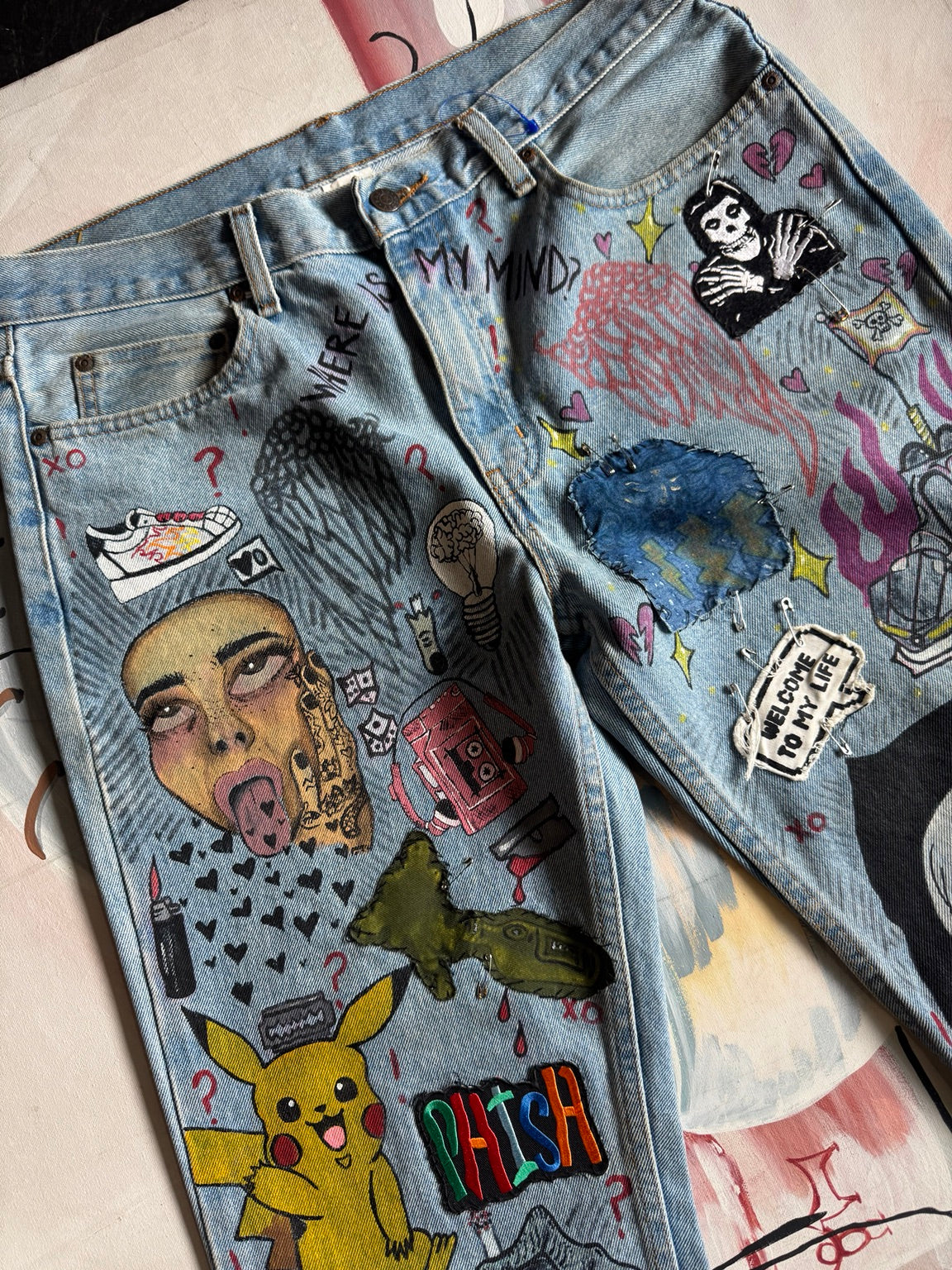 Custom hand-painted jeans artwork detail